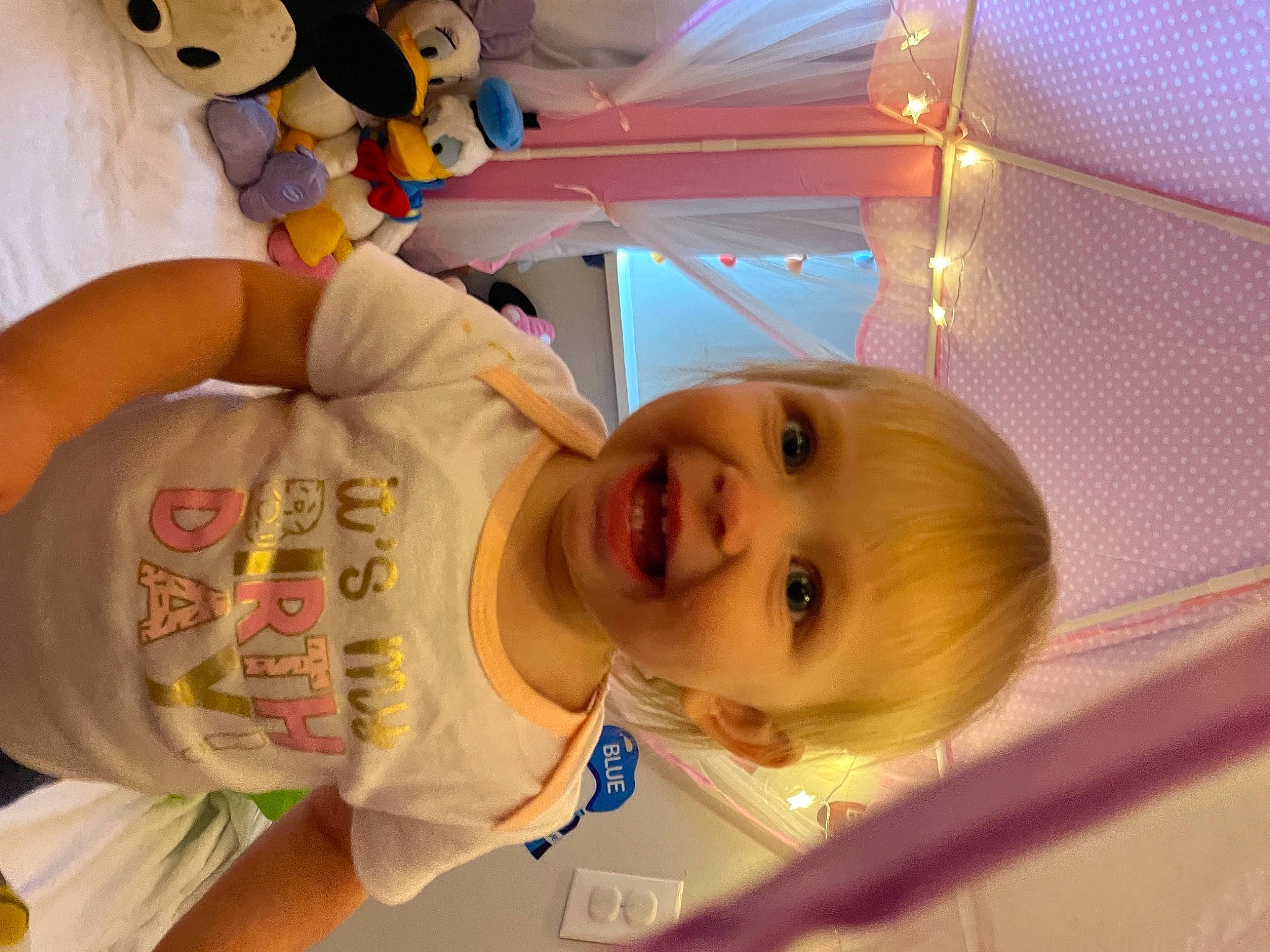 Josephine is registered to the contest to win money with this photo: baby, baby_products, baby_toddler_clothing, cheek, child, fun, happy, mouth, nose, organ, person, product, room, skin, sleeve, smile, t_shirt, toddler, toy, white