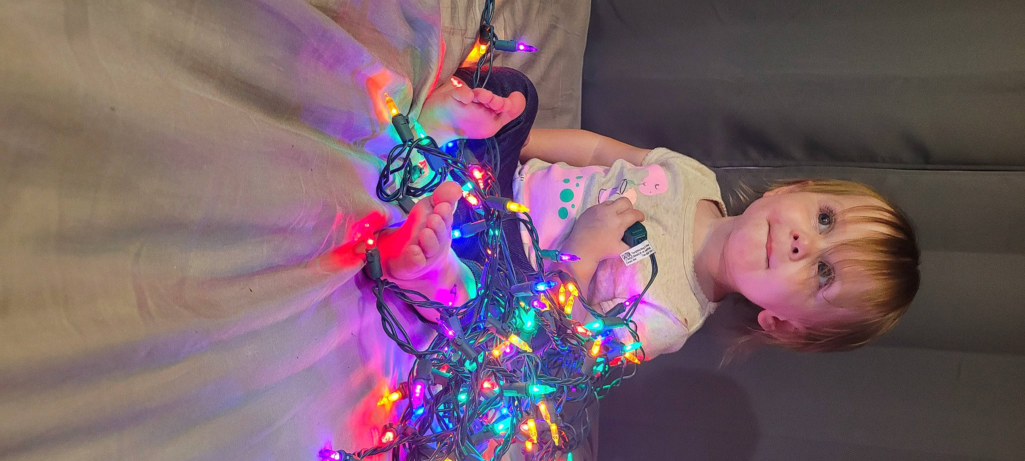 Annaliese is registered to the contest to win money with this photo: christmas_decoration, christmas_ornament, electric_blue, entertainment, event, fun, magenta, night, ornament, party, performance_art, performing_arts, person, pink, plant, purple, toddler, tradition, tree, violet