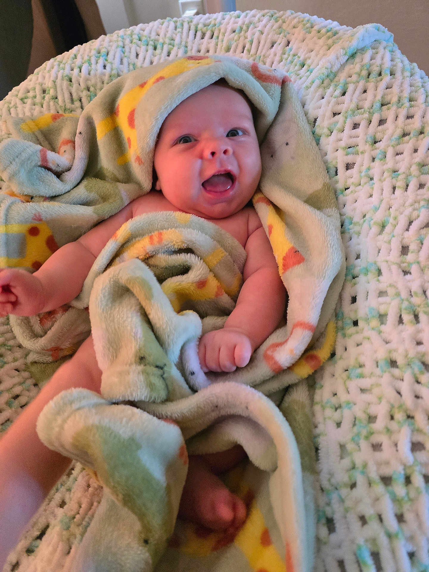Colton is registered to the contest to win money with this photo: baby, blanket, giraffe_print, smiling, happy, infant, wrapped, cute, soft_texture, crocheted_surface, skin, cheerful, small_hands, small_feet, indoors, comfort, child, portrait, warm, cozy