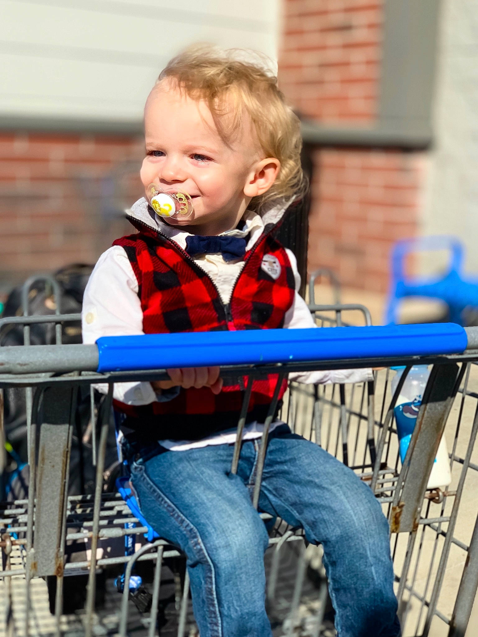 Elijah is registered to the contest to win money with this photo: baby, child, design, jeans, joy, pattern, person, plaid, sitting, smile, tartan, toddler, vehicle