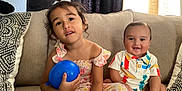 Jomar Keriel is registered to the contest to win money with this photo: child, children, baby, toddler, balloon, couch, pillow, smile, happy, indoor, clothing, patterned, curtain, hair_bow, sitting, face, cute, family, portrait, home
