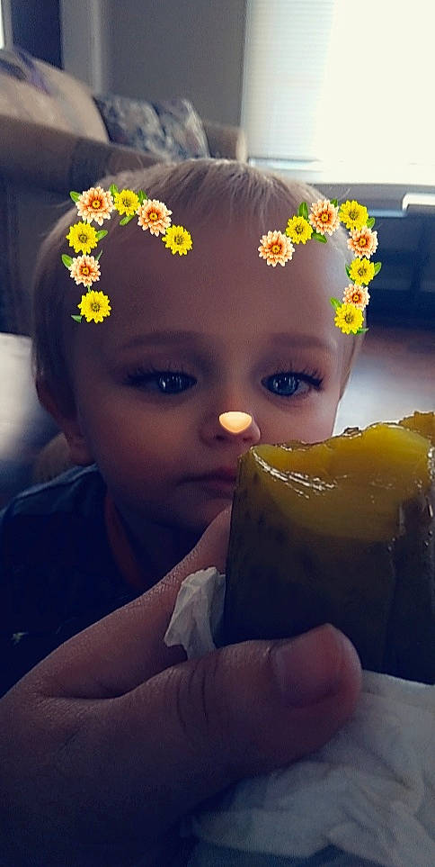 Jeremiah is registered to the contest to win money with this photo: black_hair, child, cool, dress, eye, eyebrow, eyelash, flash_photography, flower, fruit, hairstyle, happy, hat, headgear, headpiece, jewellery, lip, person, petal, plant