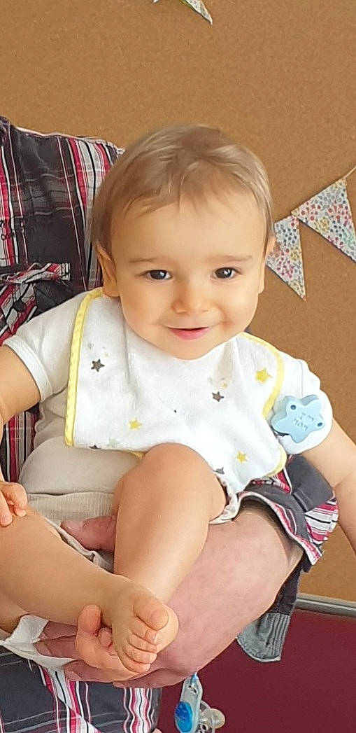 Lény participe au concours pour gagner de l'argent avec cette photo : baby, baby_toddler_clothing, cheek, child, face, finger, hairstyle, happy, head, human_body, human_leg, iris, joy, knee, leg, person, skin, sleeve, smile, tartan