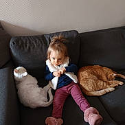 Caramel participe au concours pour gagner de l'argent avec cette photo : toddler, child, cat, white_cat, orange_cat, couch, indoor, wallpaper, sitting, boots, fur, pet, relaxing, furniture, cozy, home, portrait, cute, young_child, resting