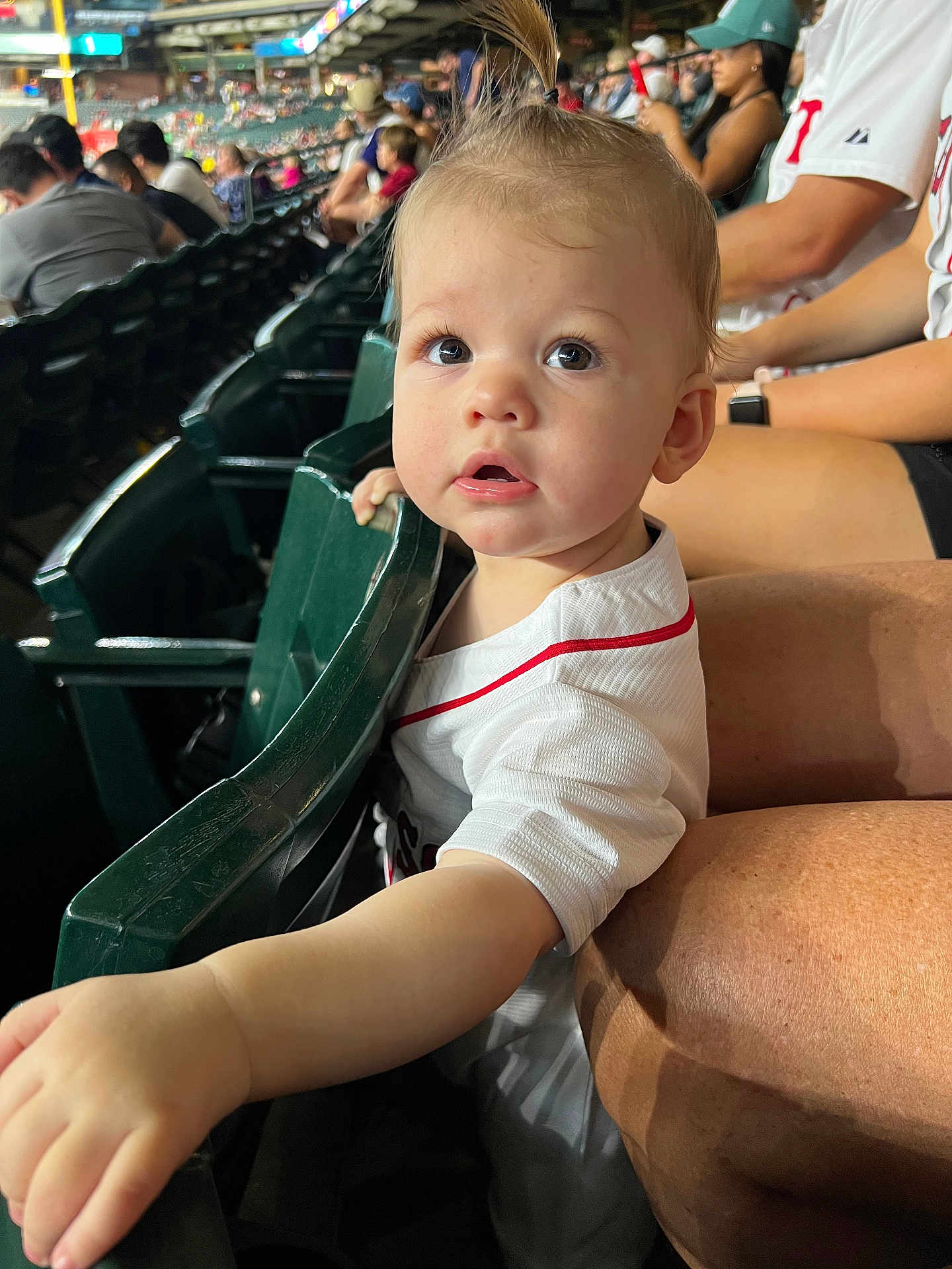 Brady joined the competition — help win amazing prizes! toddler, child, stadium, seating, sports_jersey, crowd, person, curious, mohawk, reaching_hand, spectator, event, casual_clothing, daylight, family, public_place, face, expression, indoor, people
