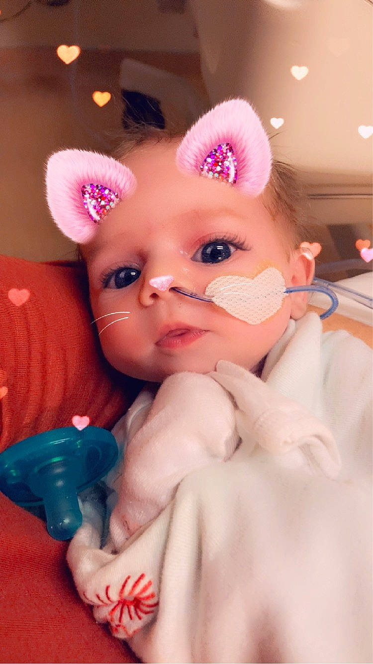 Amanda is registered to the contest to win money with this photo: baby, cap, child, eyelash, fashion_accessory, finger, fun, gesture, hand, happy, headpiece, lip, mouth, nail, nose, person, pink, skin, thumb, toddler