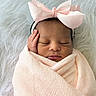 newborn, baby, sleeping, pink_bow, blanket, wrapped, infant, cute, peaceful, resting, soft_texture, headband, hand, face, portrait, fluffy_background, cozy, closeup, toddler, adorable
