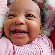 Aureliana is registered to the contest to win money with this photo: baby, blanket, cheerful, child, closeup, cozy, cute, expression, face, happy, indoors, infant, person, pink_clothing, portrait, skin, smiling, soft_texture, toddler, young