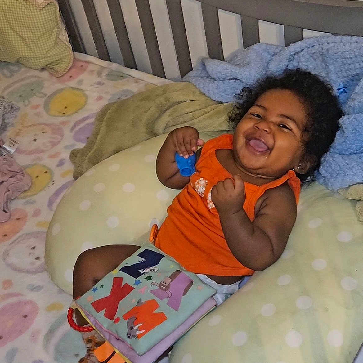 Jream is registered to the contest to win money with this photo: baby, bed, bedroom, blanket, couch, crib, cushion, face, furniture, happy, head, homedecor, indoors, infantbed, laughing, person, photography, pillow, portrait, room