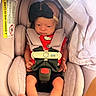 Ahzara Ourlanii is registered to the contest to win money with this photo: baby, infant, car_seat, headband, black_bow, red_clothing, hello_kitty, safety_harness, feet, pink, soft_fabric, newborn, child, cute, indoors, seatbelt, person, small_hands, baby_gear, resting