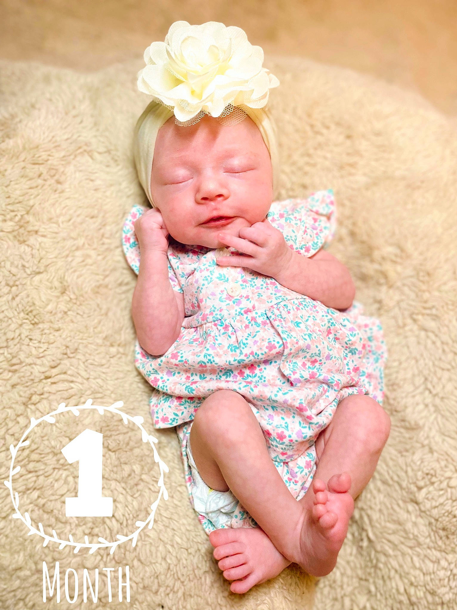 Isabelle is registered to the contest to win money with this photo: baby, baby_toddler_clothing, child, dress, fashion_accessory, finger, flower, foot, fun, grass, happy, head, headband, headpiece, person, petal, pink, sitting, skin, toddler