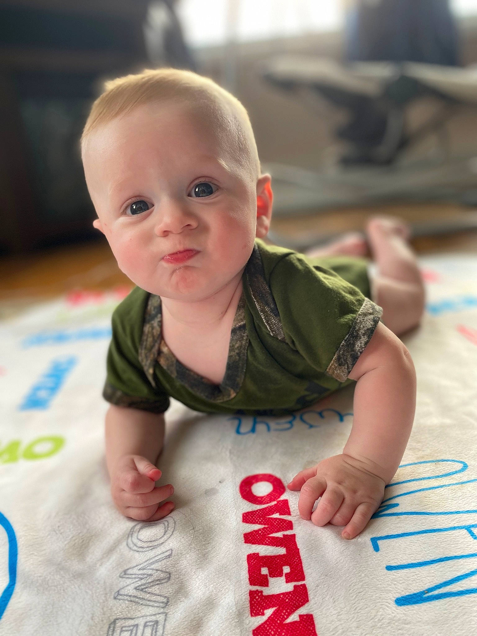Owen joined the competition — help win amazing prizes! baby, baby_toddler_clothing, carmine, cheek, child, dress, face, floor, flooring, fun, hairstyle, happy, hardwood, head, person, sitting, skin, sleeve, t_shirt, toddler