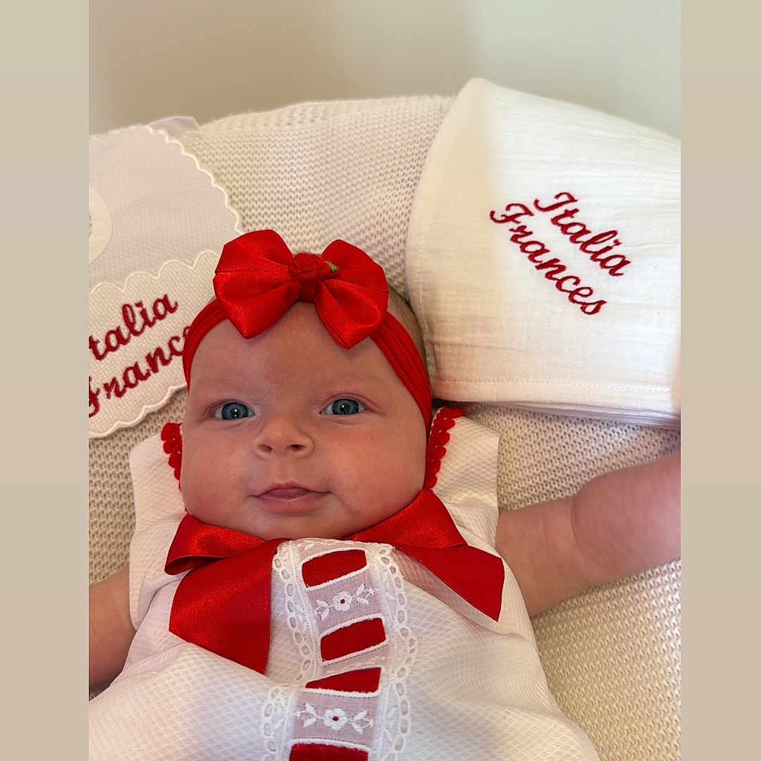 Italia Frances is registered to the contest to win money with this photo: baby, bodypart, bonnet, cap, clothing, cushion, face, finger, furniture, hand, happy, hat, head, homedecor, hood, newborn, person, photography, portrait, smile