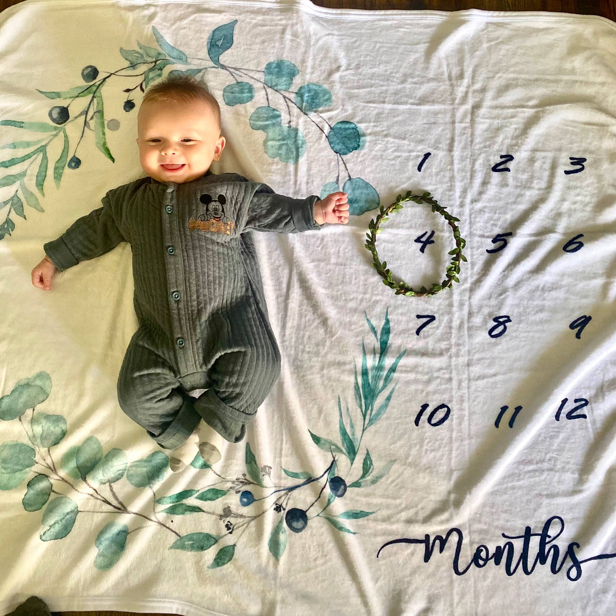 Bryce is registered to the contest to win money with this photo: baby, baby_toddler_clothing, bedding, chair, child, comfort, font, joy, linens, pattern, person, product, quilt, room, sitting, sleeve, smile, t_shirt, textile, toddler