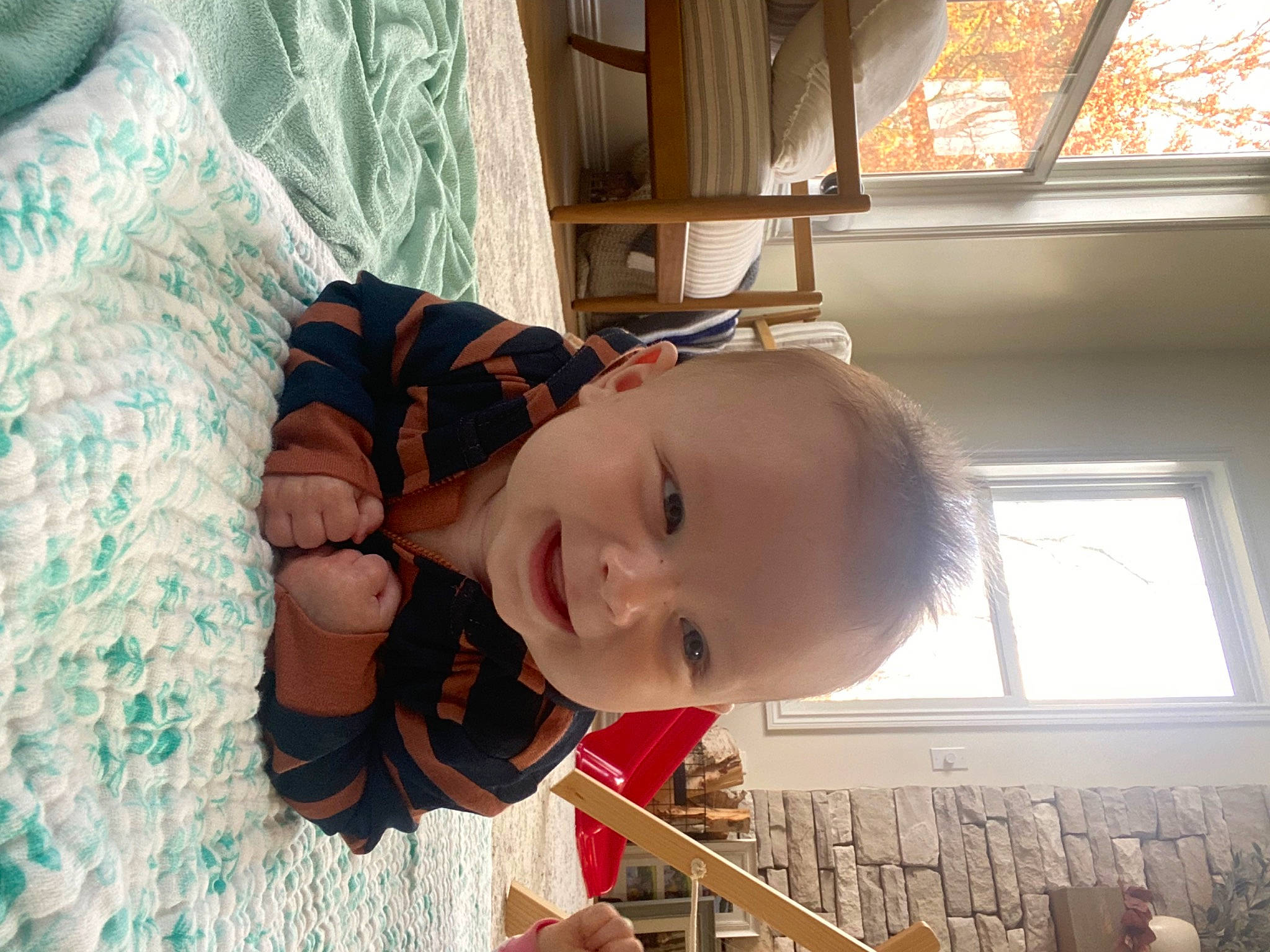 Bryce is registered to the contest to win money with this photo: baby, child, elbow, fun, happy, human_body, leisure, mouth, nose, pattern, person, play, room, sitting, skin, smile, toddler, tree, vacation, window