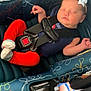 Mariana is registered to the contest to win money with this photo: baby, car_seat, sleeping, child, infant, seatbelt, red_pants, white_bow, headband, sock, footwear, blue_sandal, floor, straps, fabric_pattern, child_safety, indoor, resting, peaceful, person