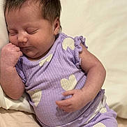 Mariana joined the competition — help win amazing prizes! baby, sleeping, infant, purple_outfit, heart_pattern, soft_surface, peaceful, cute, newborn, relaxed, child, portrait, indoor, small_hands, closed_eyes, resting, cozy, human, young, adorable