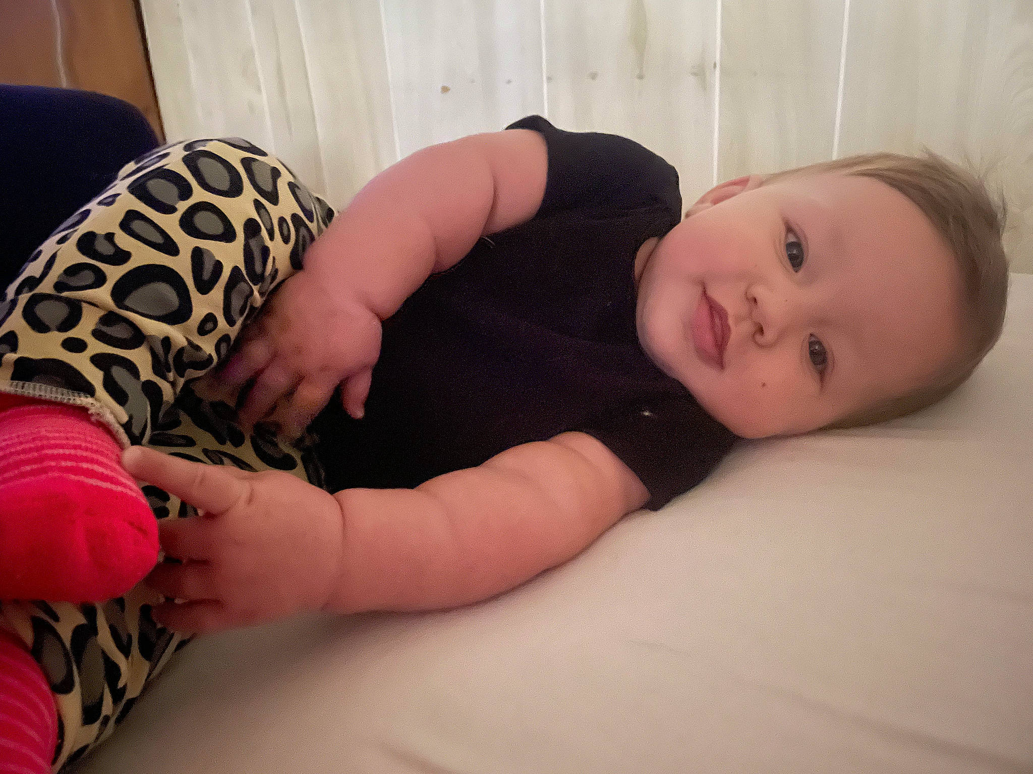 Pepper is registered to the contest to win money with this photo: arm, baby, baby_toddler_clothing, cheek, child, comfort, elbow, eye, finger, flooring, hand, human_leg, joint, knee, linens, person, sitting, skin, thigh, toddler