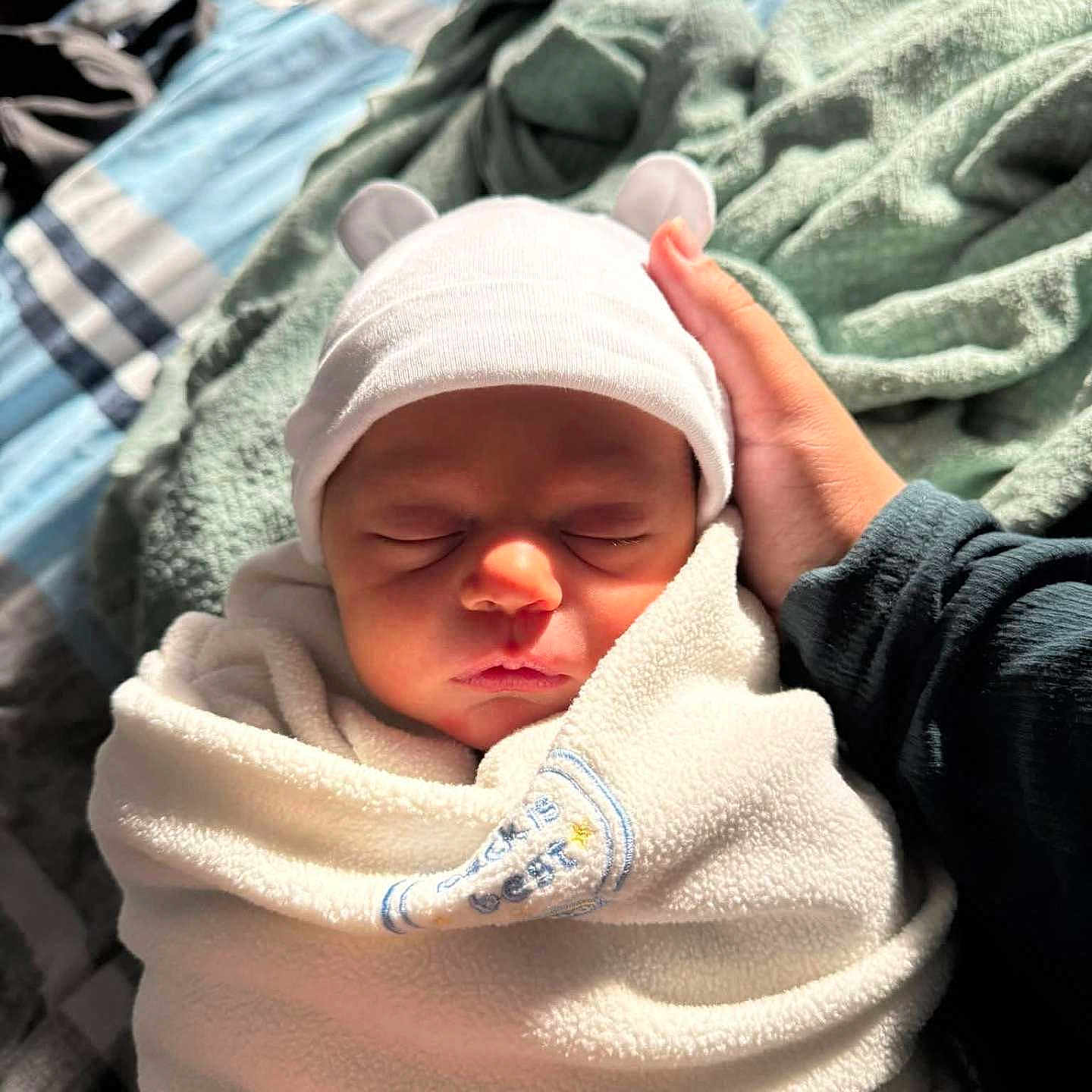 Asher joined the competition — help win amazing prizes! baby, bed, blanket, cozy, cute, fabric, hand, hat, headwear, indoor, infant, newborn, peaceful, person, portrait, rest, skin, sleeping, soft, wrapped