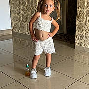 Chelsea a rejoint le concours — aidez-le/la à gagner de superbes lots ! bottle, carpet, casual, child, door, expression, girl, hands_on_hips, indoor, knitted_clothing, orange_liquid, pigtails, pose, reflection, stone_wall, tiled_floor, white_shoes, white_shorts, white_top, young_child