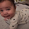 Kaidyn is registered to the contest to win money with this photo: baby, infant, onesie, star_pattern, tummy_time, play_mat, smile, face, cute, indoor, child, clothing, floor, home, person, young_child, expression, cozy, blanket, soft_lighting