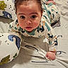 Kaidyn joined the competition — help win amazing prizes! baby, child, infant, dinosaur_print, onesie, blanket, pillow, indoor, floor, curly_hair, wide_eyes, crawling, cute, soft_texture, home, playtime, toddler, portrait, looking_up, cozy
