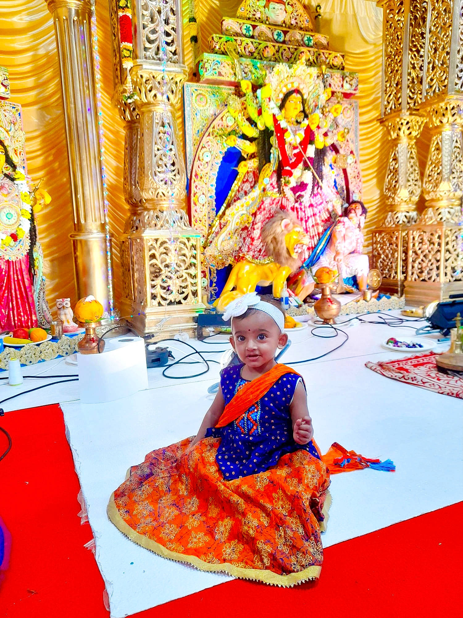 Arunita participe au concours pour gagner de l'argent avec cette photo : art, chair, decoration, event, flooring, fun, leisure, magenta, pattern, person, place_of_worship, ritual, room, sitting, temple, textile, toddler, tradition, visual_arts, yellow