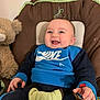 Ayden a rejoint le concours — aidez-le/la à gagner de superbes lots ! baby, babylaughing, chair, clothing, couch, cushion, face, furniture, happy, head, homedecor, newborn, pants, person, photography, portrait, sitting, t_shirt, teddybear, toy