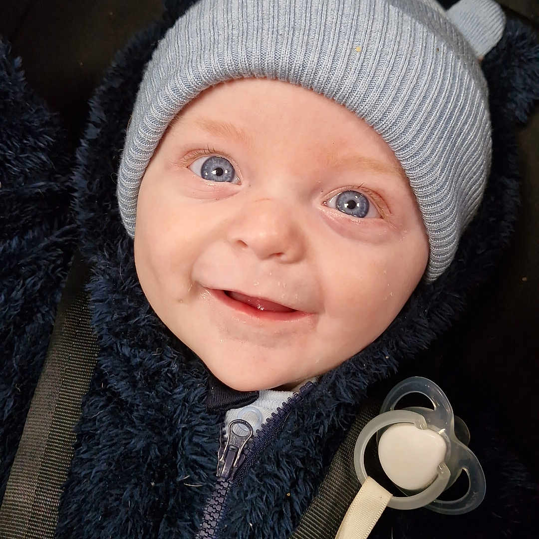Alfie-Ryder joined the competition — help win amazing prizes! baby, blue_eyes, car_seat, child, closeup, cozy, cute, face, happy, hat, infant, jacket, knit_hat, navy_blue, pacifier, person, portrait, smile, strap, winter_clothing