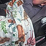 baby, child, car_seat, blanket, animal_print, hand, sucking, face, clothing, seatbelt, interior, car, cute, infant, young_child, comfort, warm, portrait, closeup, relaxed