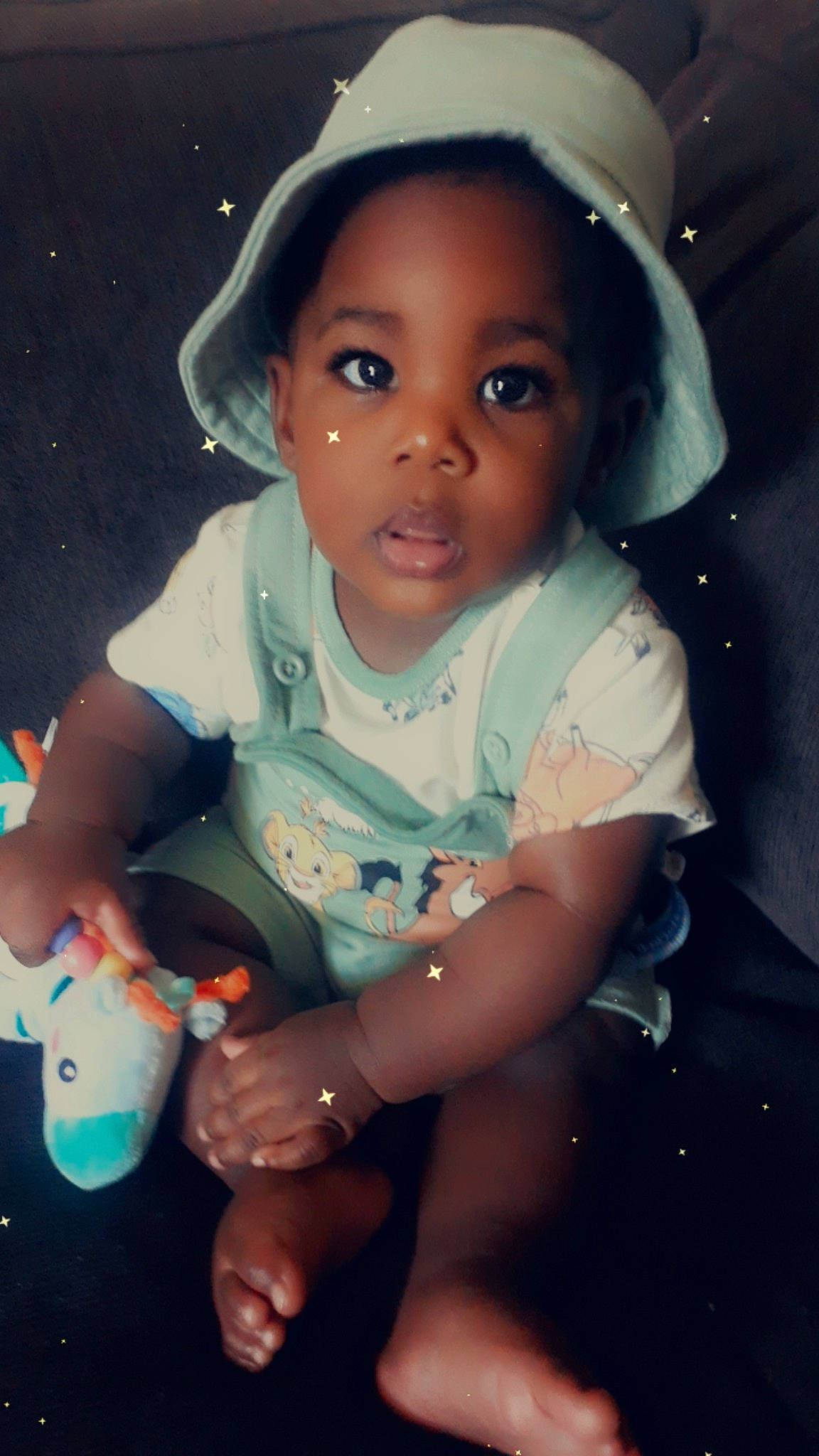 Dante is registered to the contest to win money with this photo: arm, baby_toddler_clothing, cap, cheek, cool, eye, facial_expression, finger, flash_photography, fun, happy, iris, lip, mouth, nose, organ, person, pink, skin, sleeve