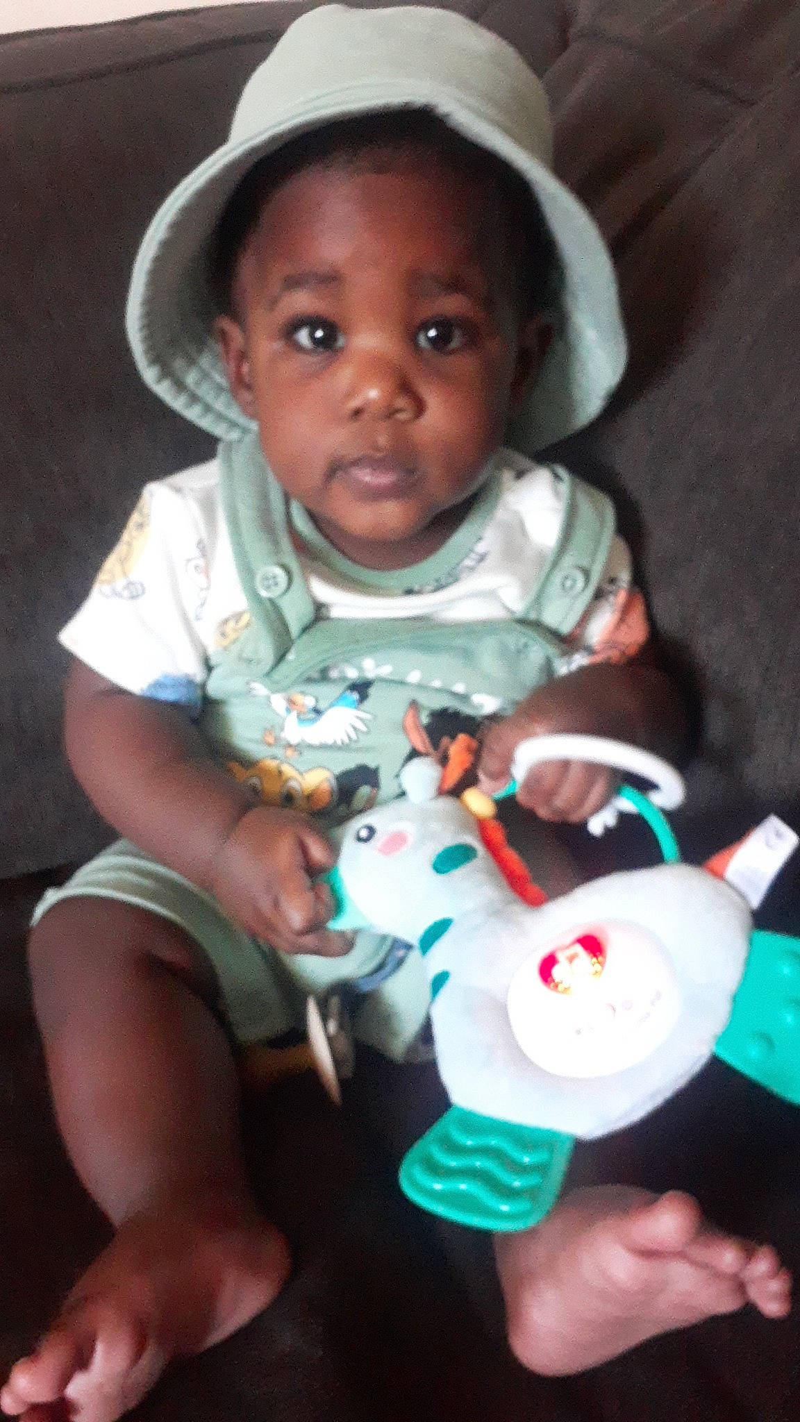 Dante is registered to the contest to win money with this photo: baby, baby_toddler_clothing, cheek, child, facial_expression, finger, fun, hand, happy, lip, mouth, nose, organ, person, pink, skin, sun_hat, t_shirt, toddler, toy