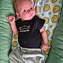 baby, infant, child, black_shirt, little_gentleman, winnie_the_pooh, blanket, gray_pants, lying_down, cute, curious, indoors, soft_toys_pattern, newborn, small_hands, casual_clothing, comfort, portrait, expression, resting