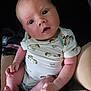 baby, infant, child, person, cute, onesie, hedgehog_pattern, skin, hands, feet, lap, seated, curious_eyes, portrait, soft_lighting, indoor, human, newborn, expression, closeup