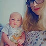 baby, woman, glasses, holding, indoor, portrait, cute, child, person, apparel, onesie, face, smile, blond_hair, young_child, parent, family, casual, expression, toddler