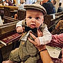 Rudi is registered to the contest to win money with this photo: baby, child, tweed_outfit, bow_tie, cap, church, pews, stained_glass, adult_hand, curious_expression, vintage_clothing, indoor, portrait, person, seated_people, wooden_bench, close_up, cute, formal_wear, infant