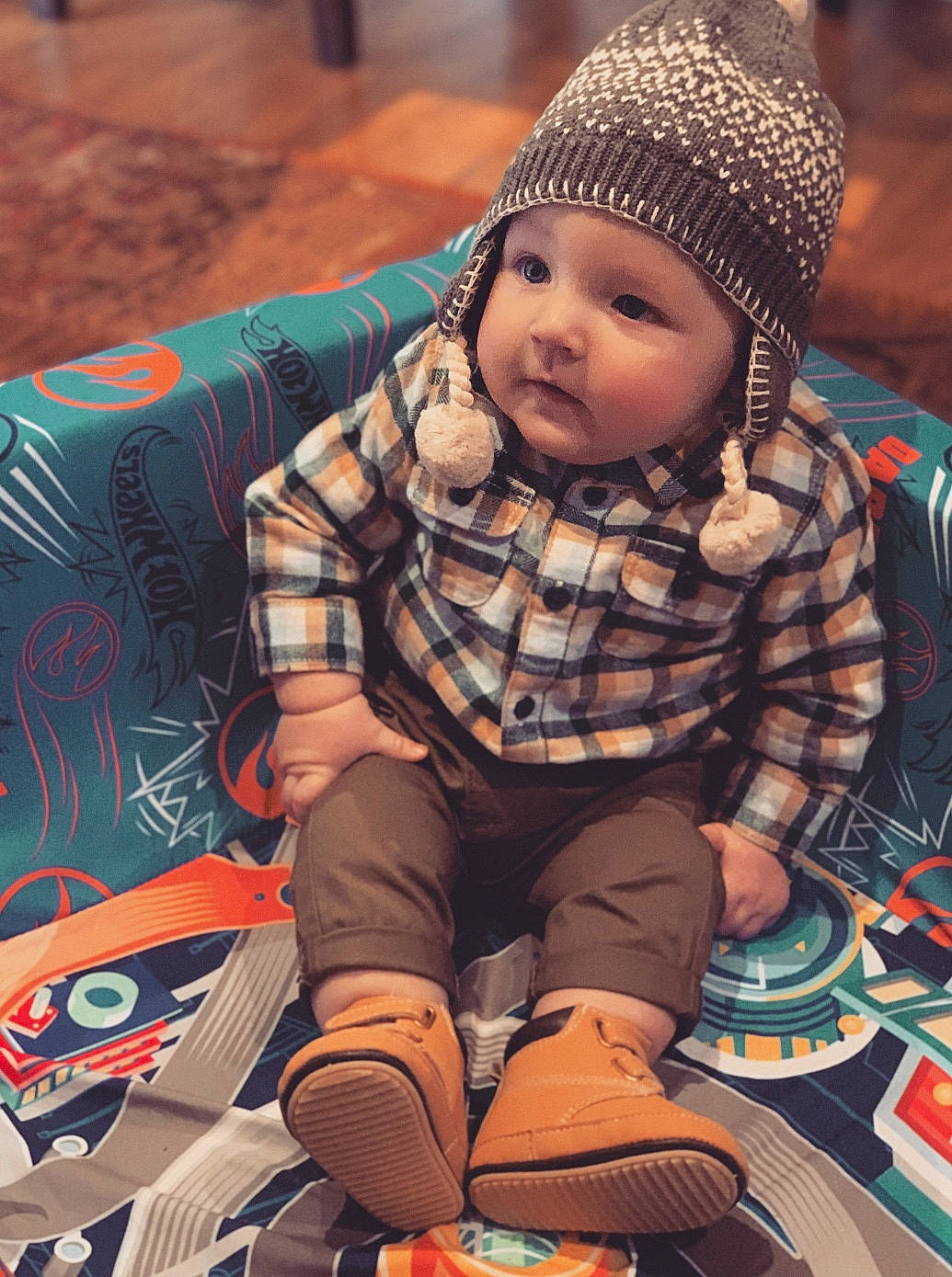 Kruz is registered to the contest to win money with this photo: baby, beanie, cap, cheek, child, child_model, cool, design, face, head, headgear, human, knit_cap, male, pattern, people, person, plaid, sitting, toddler