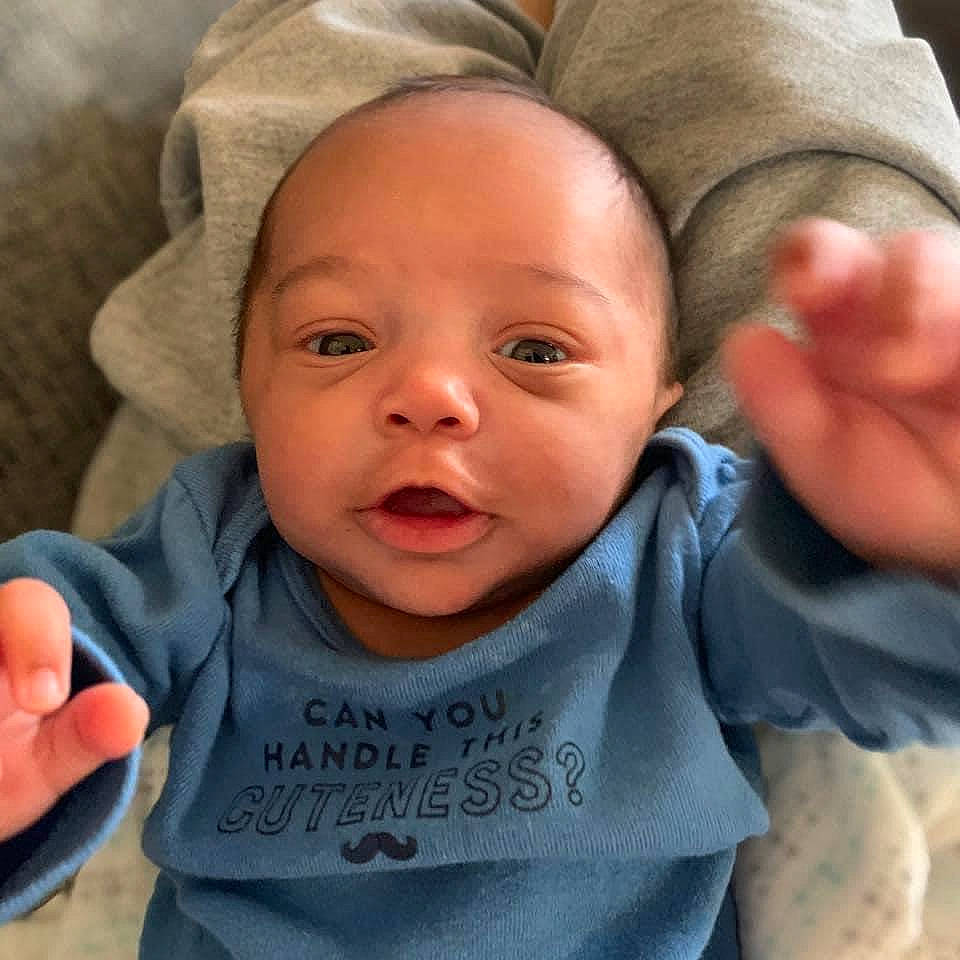 Dashawn is registered to the contest to win money with this photo: baby_toddler_clothing, cheek, chin, comfort, ear, eye, eyebrow, finger, forehead, hand, head, lip, mouth, neck, nose, organ, person, product, skin, sleeve