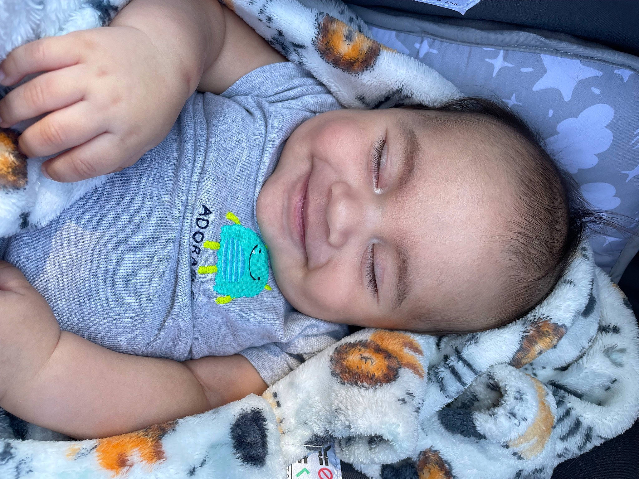 Antonio joined the competition — help win amazing prizes! arm, baby, baby_toddler_clothing, blue, cheek, clothing, comfort, eye, face, finger, hand, iris, joy, mouth, nose, orange, organ, person, skin, sleeve