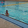 active, blue_water, child, fun, hair_style, happy, indoor_pool, lane_divider, leisure, person, recreation, smiling, splash, swimmer, swimming_pool, swimwear, tile_floor, water, waving, youth