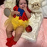 Lisa joined the competition — help win amazing prizes! baby, infant, six_months, snow_white_costume, red_bow, yellow_tutu, red_socks, curly_hair, apple, mirror, fur_blanket, pink_blanket, cute, smiling, playful, portrait, child, soft_lighting, indoor, costume