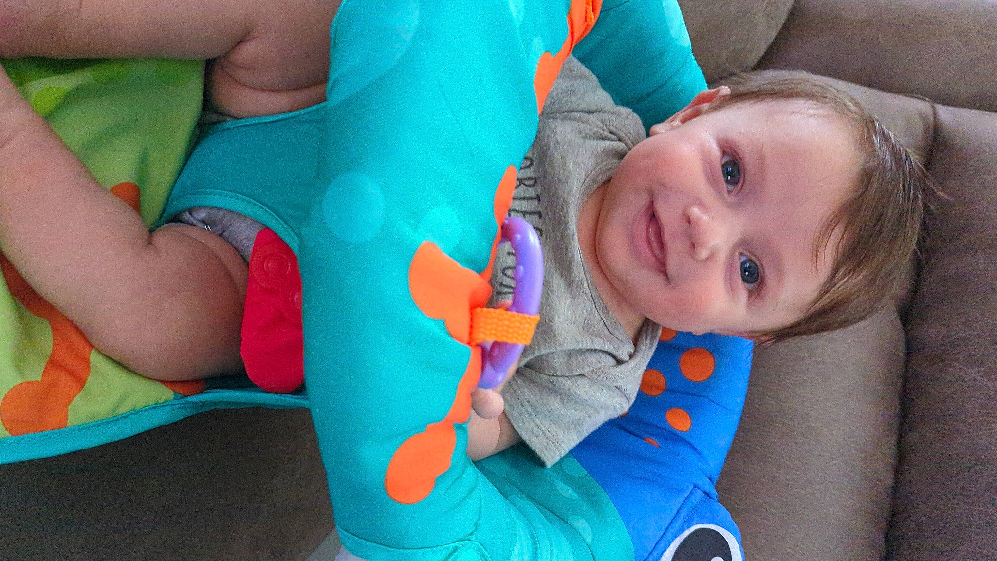 Skylar is registered to the contest to win money with this photo: azure, baby_toddler_clothing, blue, cheek, comfort, facial_expression, finger, hand, human_body, joint, joy, leg, mammal, mouth, nose, organ, person, product, skin, smile