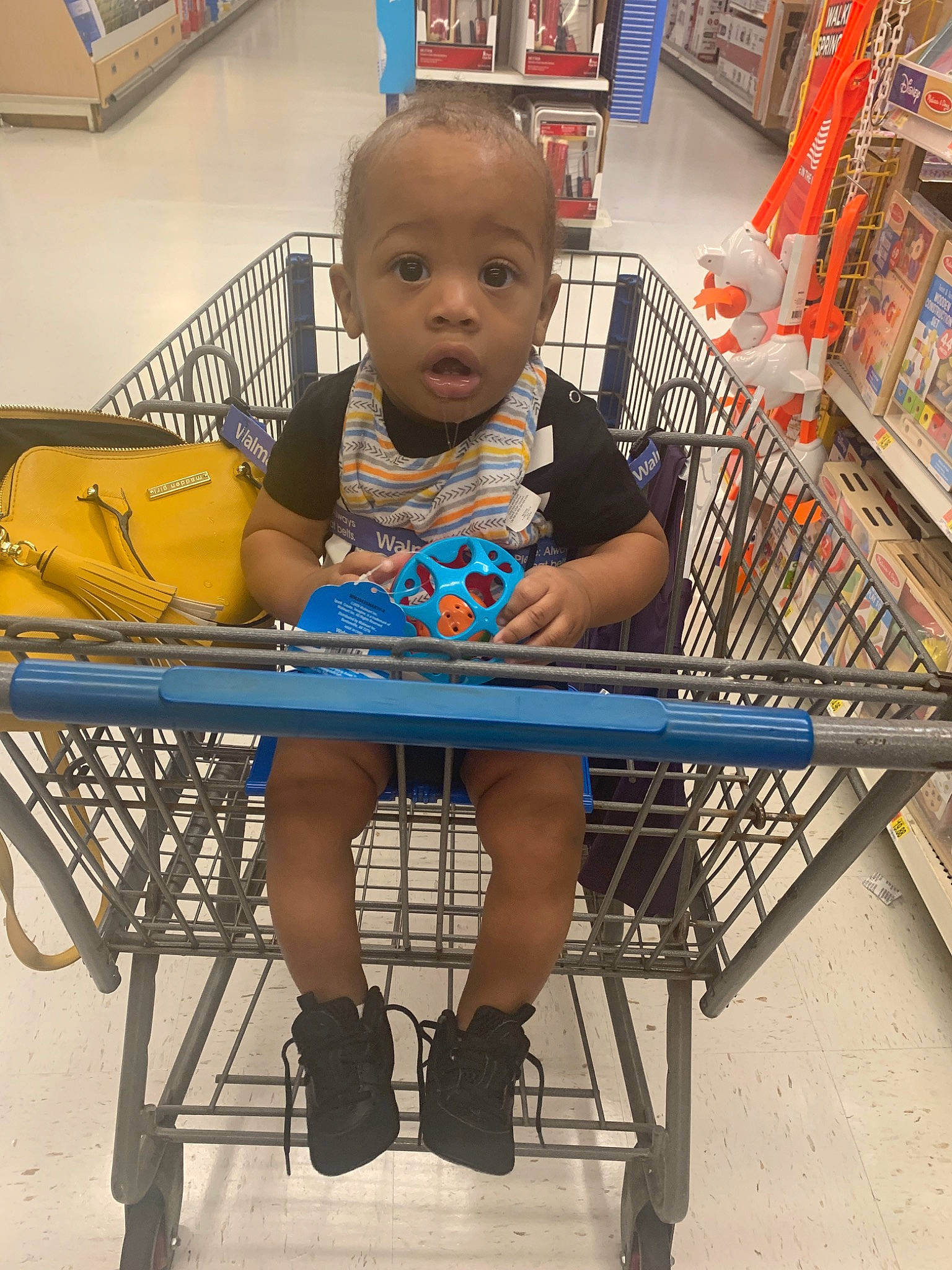 Ayaan is registered to the contest to win money with this photo: cart, chair, child, furniture, person, shopping_cart, sitting, surprise, toddler, vehicle