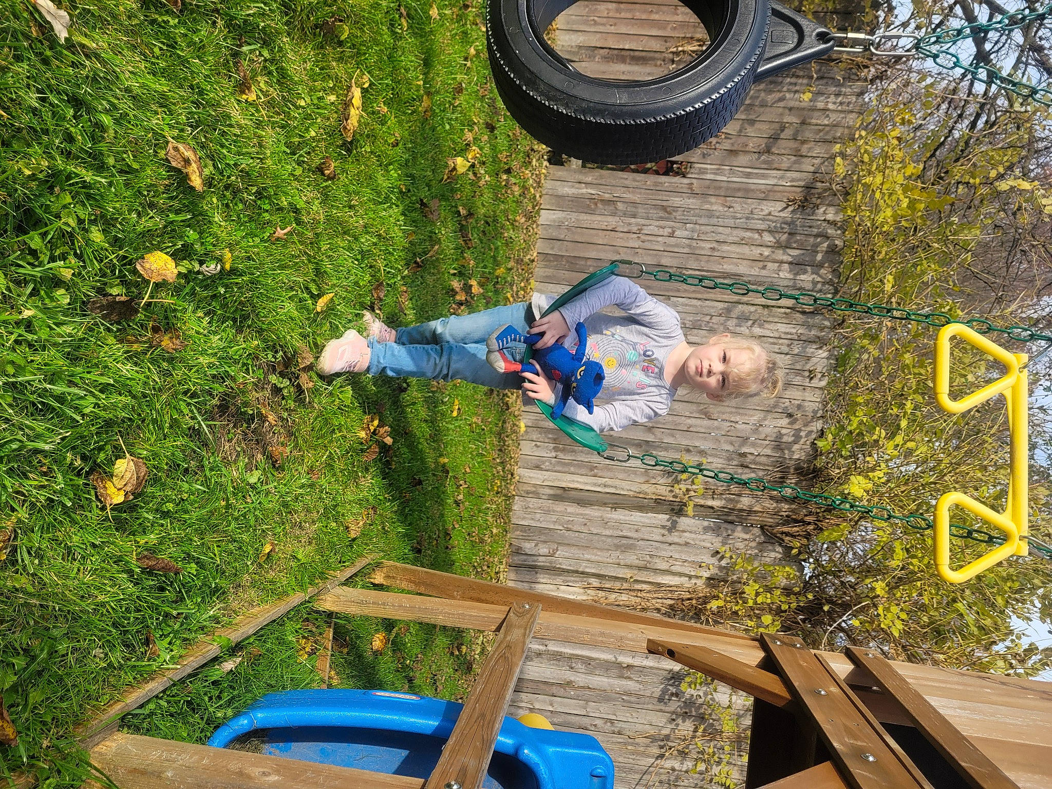 Adalynn is registered to the contest to win money with this photo: automotive_tire, blue, electric_blue, fun, grass, green, groundcover, leaf, leisure, nature, people_in_nature, person, plant, shrub, synthetic_rubber, tire, tread, tree, wheel, wood