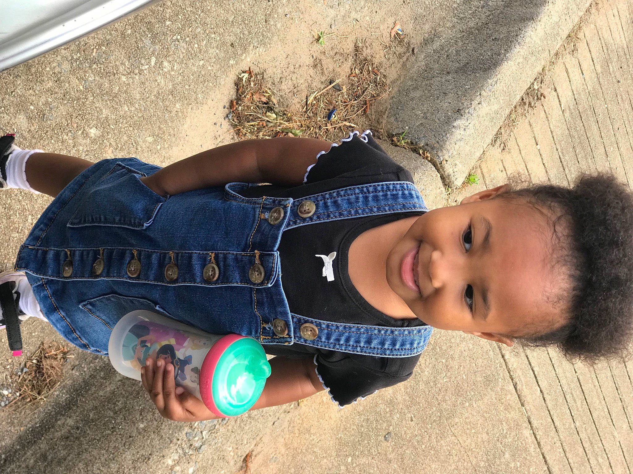 Amani is registered to the contest to win money with this photo: baby, baby_toddler_clothing, ball, child, denim, electric_blue, fun, grass, happy, human_leg, joy, knee, leisure, person, shadow, sitting, smile, sock, thigh, toddler