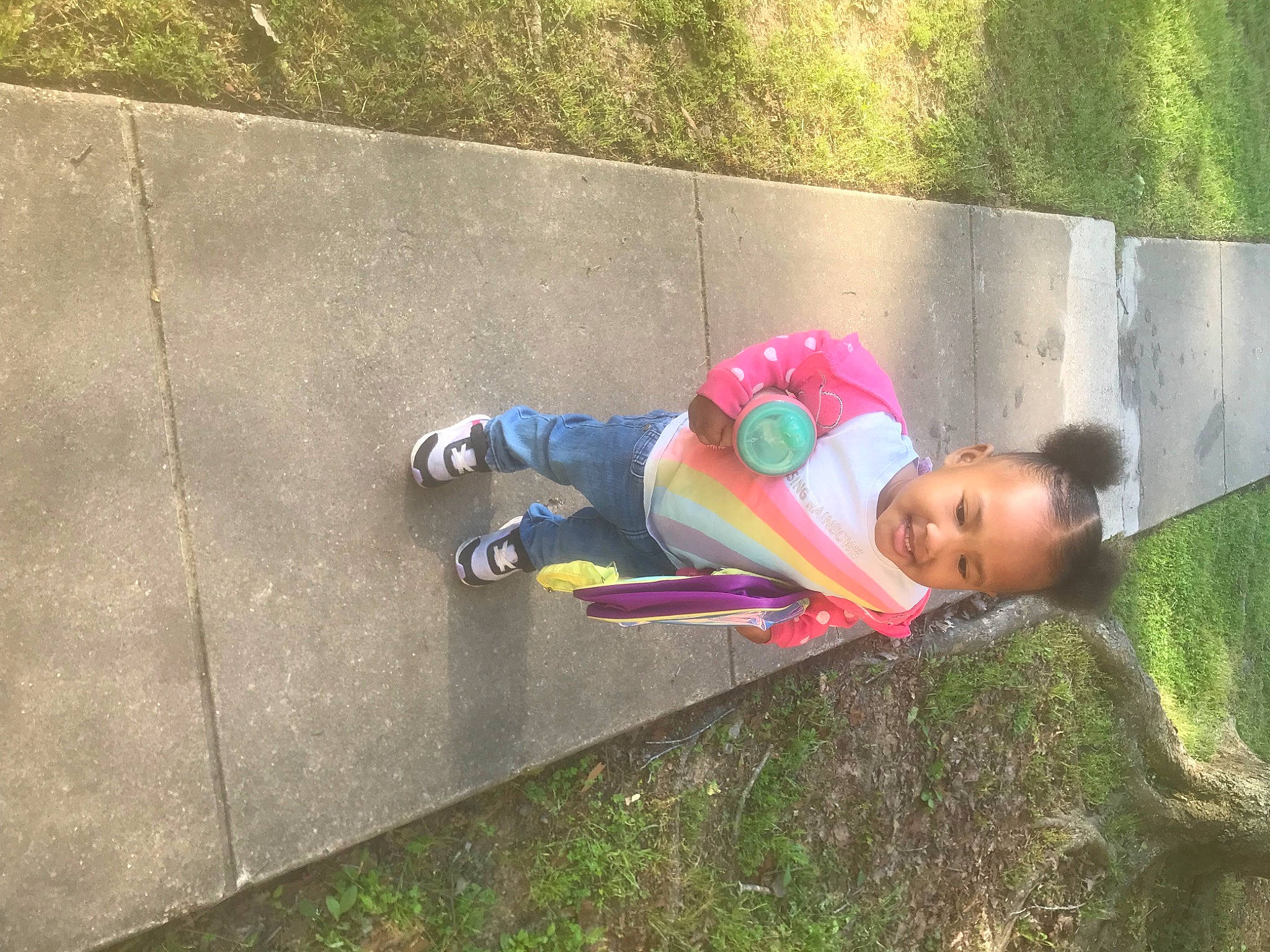 Amani joined the competition — help win amazing prizes! asphalt, child, city, concrete, fun, grass, happy, joy, leisure, magenta, people_in_nature, person, plant, play, recreation, road_surface, shadow, sidewalk, sitting, soil