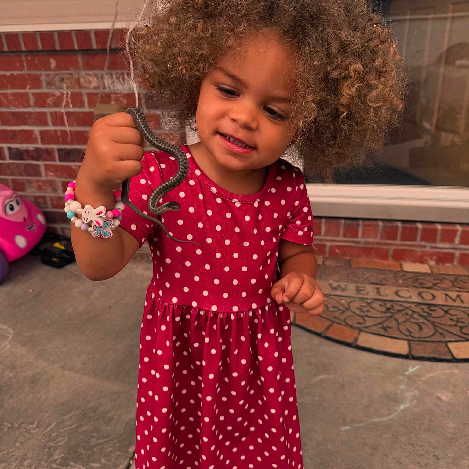 Zahara is registered to the contest to win money with this photo: bodypart, child, clothing, curlyhair, dress, face, female, finger, footwear, girl, hair, hand, happy, head, machine, person, photography, portrait, shoe, wheel