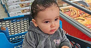 Lony a rejoint le concours — aidez-le/la à gagner de superbes lots ! aisle, casual, child, clothing, cute, expression, face, food, hair, holding, indoor, person, plastic, product, retail, shelf, shopping_cart, supermarket, toddler, toy