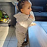 Lony a rejoint le concours — aidez-le/la à gagner de superbes lots ! casual_clothing, child, couch, curious, floor, home, hoodie, indoor, pants, person, playpen, remote_control, shoes, standing, sunlight, table, toddler, toy, window, young_child