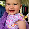 apparel, baby, cartoon_characters, cheerful, child, closeup, cute, daylight, face, happy, infant, natural_light, outdoor, person, porch, portrait, purple_dress, sitting, smiling, tulle